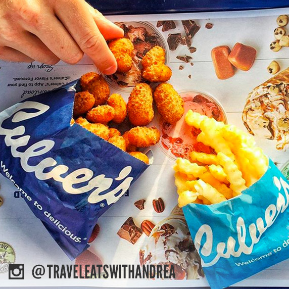 An order of Culver’s cheese curds and an order of Culver’s fries shown side-by-side on a restaurant tray.