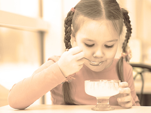 Young Girl eating an Ice Cream Sundae