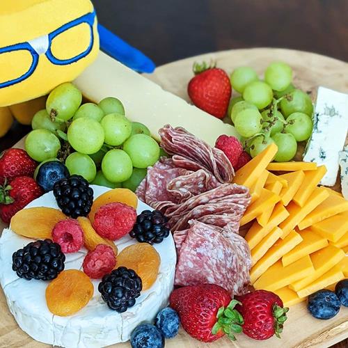 Curdis poses with finished charcuterie board. 