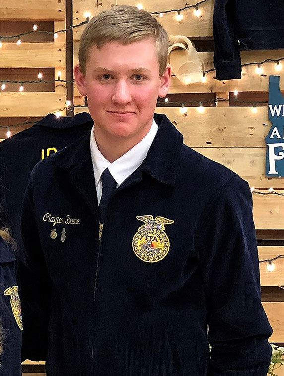 Clayton poses for a photo in his FFA blue jacket.