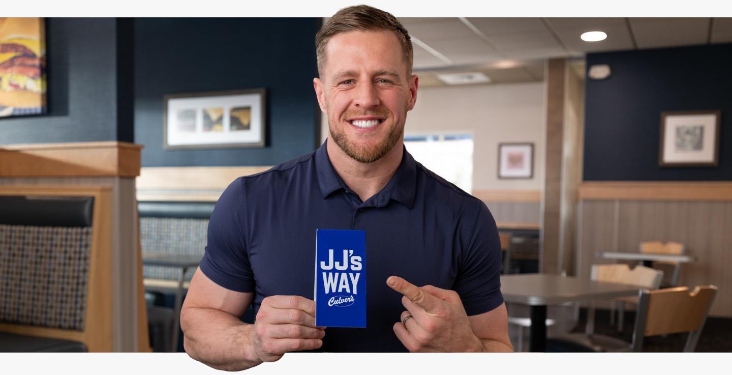 JJ Watt holding a table tent that says JJs Way