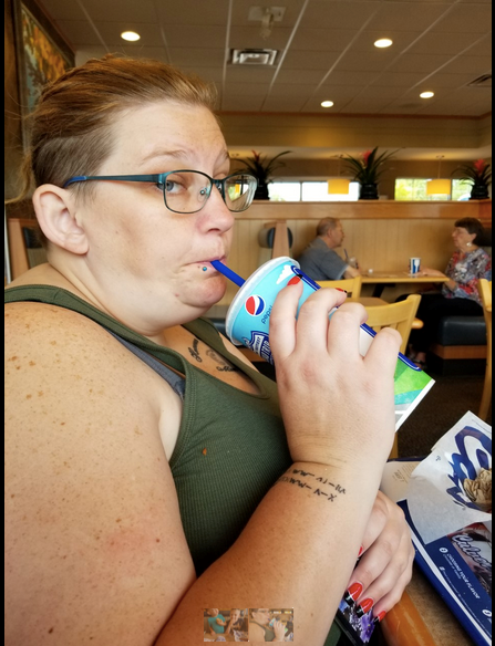 Woman drinking from a Culver's cup