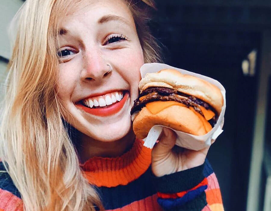 Woman smiling and holding a ButterBurger