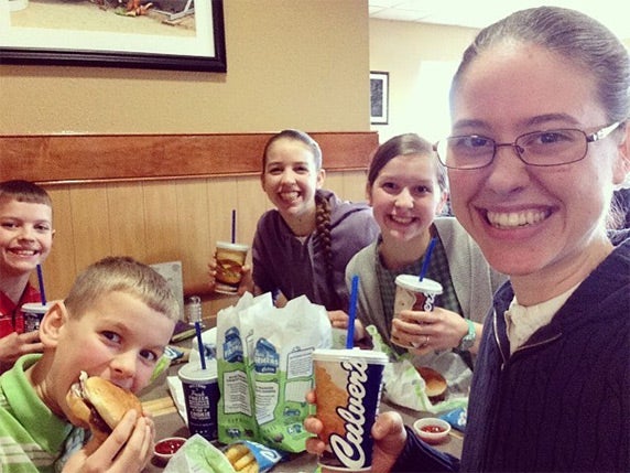 Family of five, two young boys, two young girls and mother, eating Culver’s ButterBurgers®