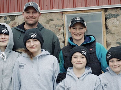 Family smiling standing outdoors