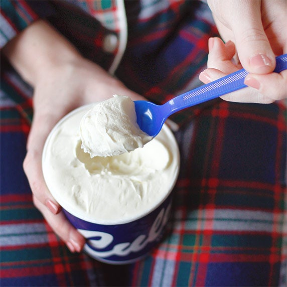 Woman eating Custard in pajamas.