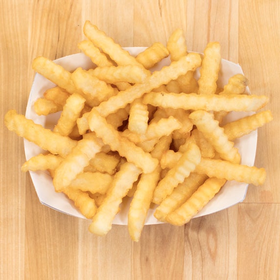 Culver’s Crinkle Cut Fries in a paper tray on a wooden table