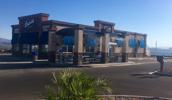 A photo of a Culver’s restaurant taken from its parking lot in a desert landscape