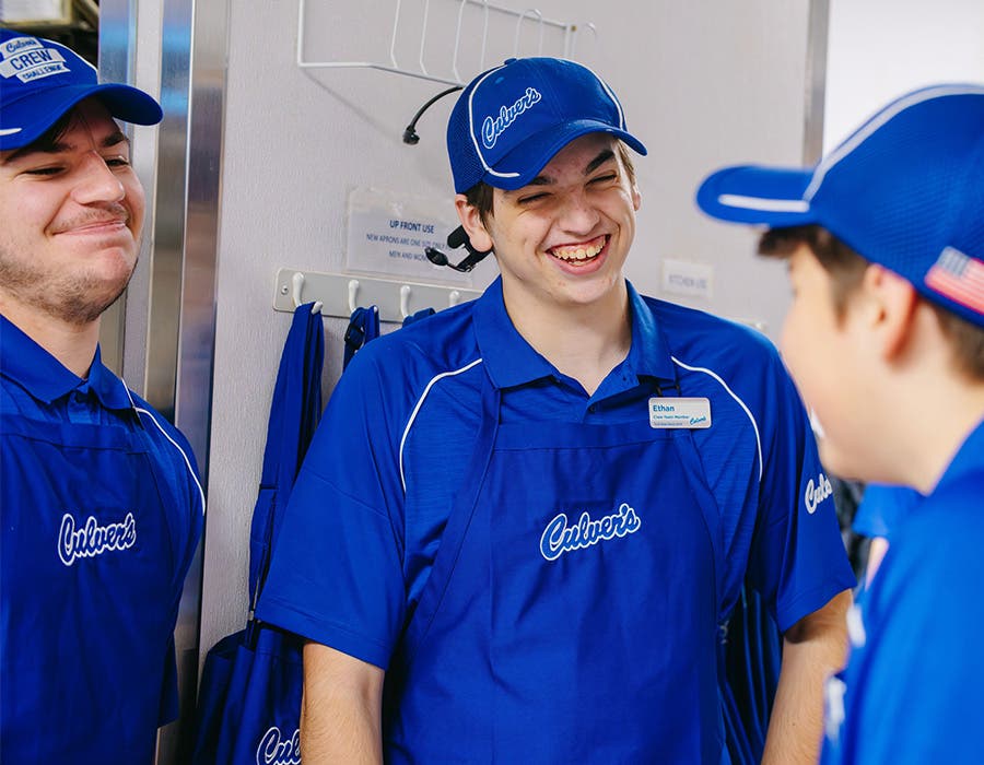 Three Culver's team members smiling with each other