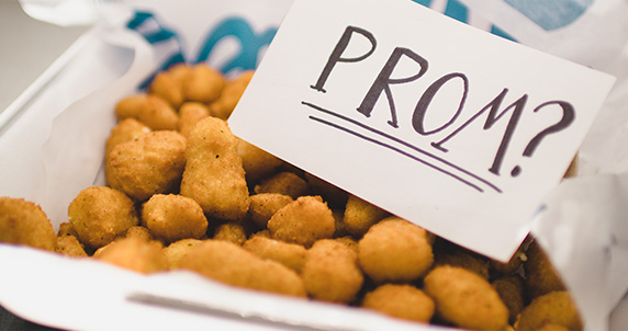 A note that reads "Prom?" sits inside a family-size order of Cheese Curds.