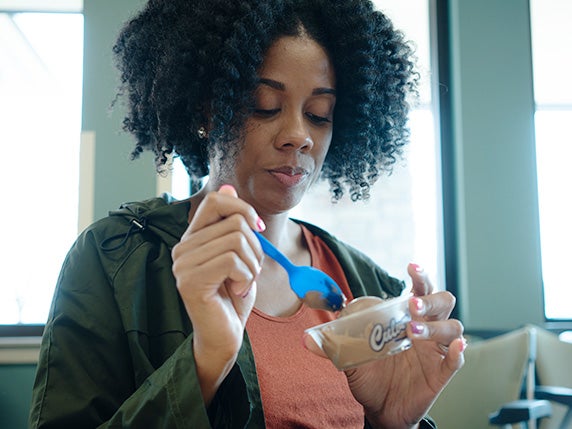 Woman is about to scoop her spoon into a dish of Culver’s Fresh Frozen Custard.