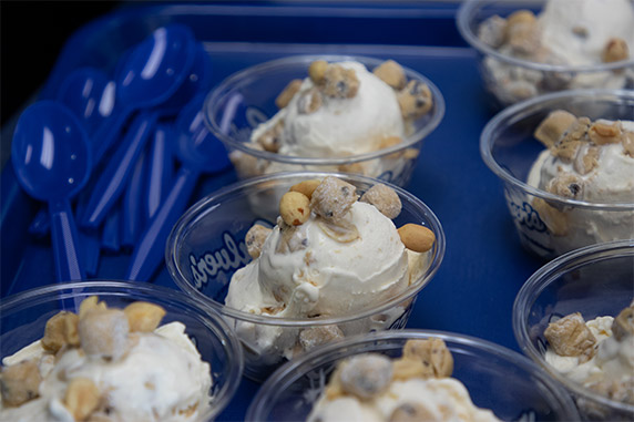 Dishes of Culver’s Fresh Frozen Custard sit on a blue tray next to a pile of blue spoons.