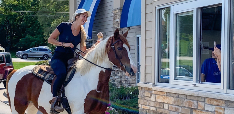 Girl riding a horse through the Culver’s Drive-Thru
