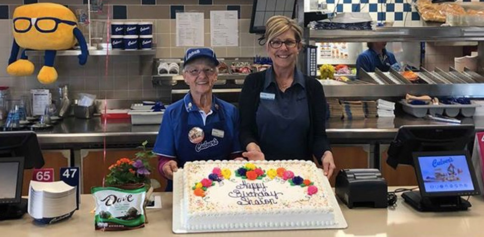 Sharon and the Culver’s restaurant owner pose with a birthday cake.