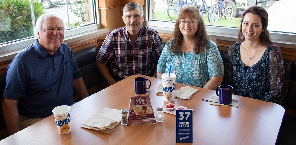 Craig Culver enjoys a meal in a corner booth with first guest Jim Olson, Jim’s wife Marion and their daughter Heather.