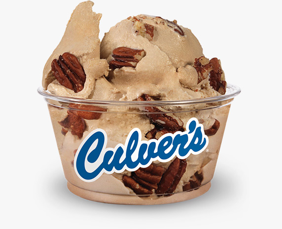 A soft-brown, butter pecan frozen custard is filled with full toasted pecans and served in a clear Culver’s dish
