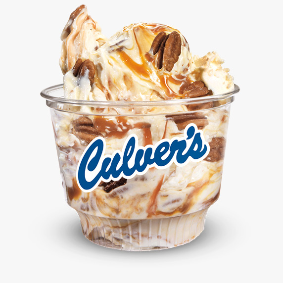 Caramel swirls and pecan pieces are mixed into vanilla frozen custard and served in a clear Culver’s dish