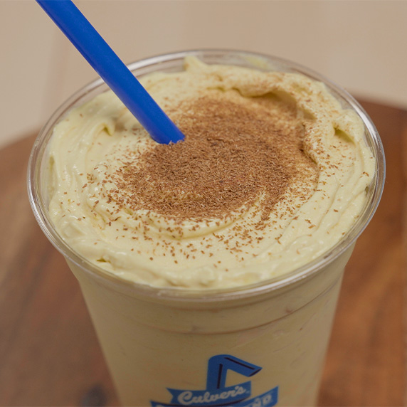 Pumpkin Spice Shake with straw rests on table.