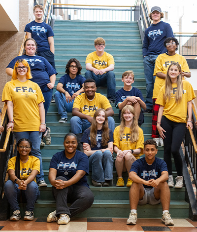  FFA members gather on a staircase.