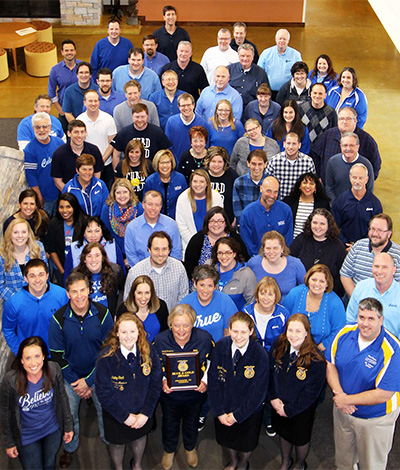 Culver’s Support Center team poses with FFA members in blue attire.