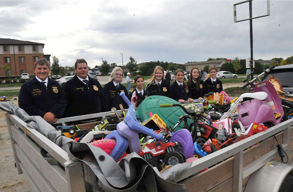 Members of the local FFA chapter round up the toy cars to donate to Goodwill 