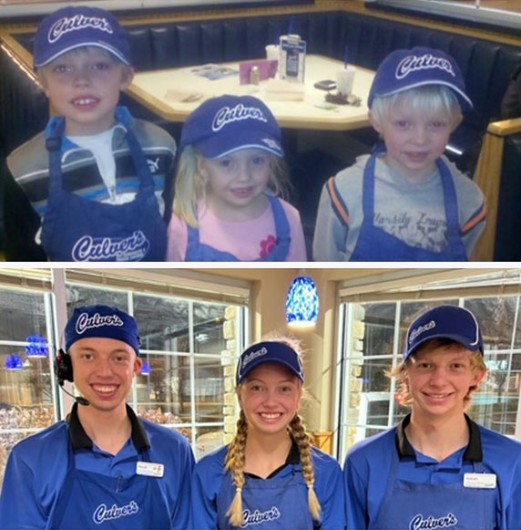 The Kuehl kids in their True Blue Crew uniforms smiling next to an old photo of them dressed up in Culver’s aprons and hats as young kids.