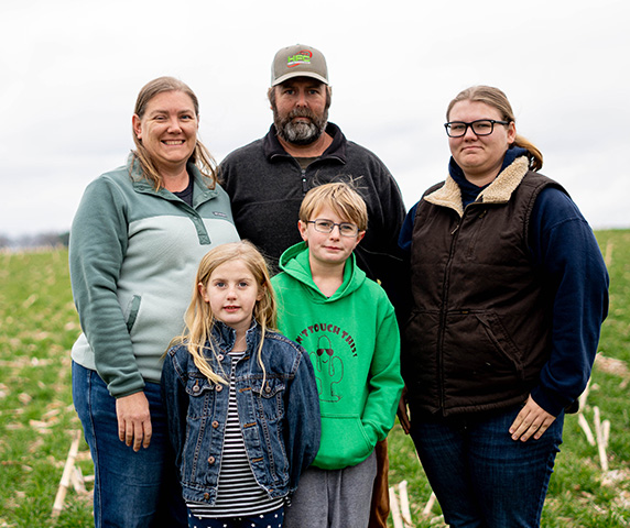 Norwood family stands on farm