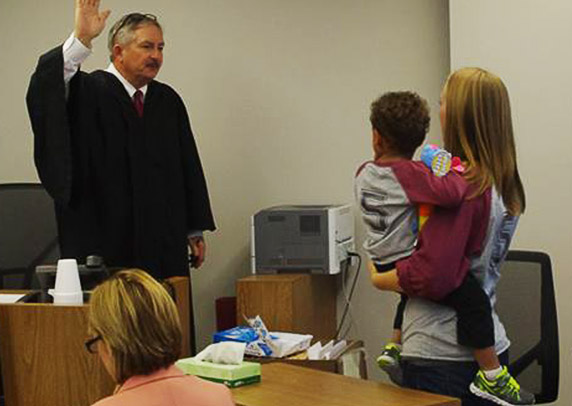 Black Hawk County Courthouse Chief Judge swears in a newly formed family