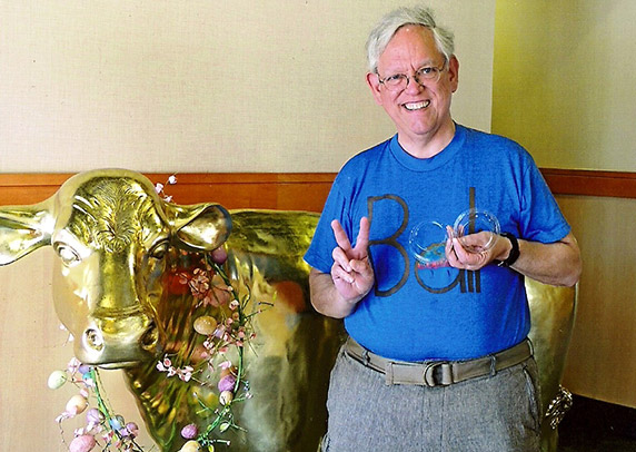 Bill poses in front of a golden cow statue for a photo marking Jane’s 200th Culver’s visit.