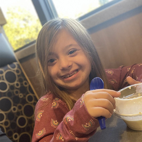 Little girl enjoying vanilla custard