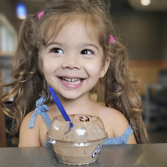 Little girl enjoying chocolate custard