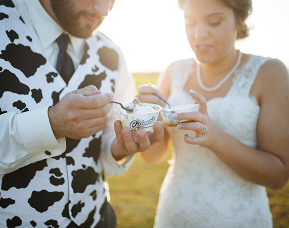 Katy and Cory B. (who is wearing a cow print vest) enjoy some Fresh Frozen Custard at their wedding.