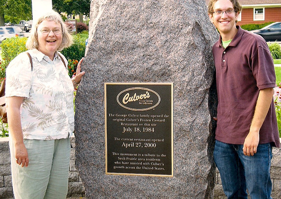 Jane and her son Eddie pose in front of a historical marker at the Culver’s of Sauk City, WI.