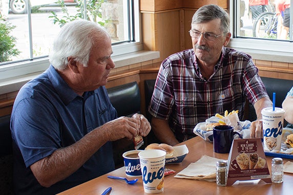 Craig Culver enjoys a meal in a corner booth with first guest Jim Olson.