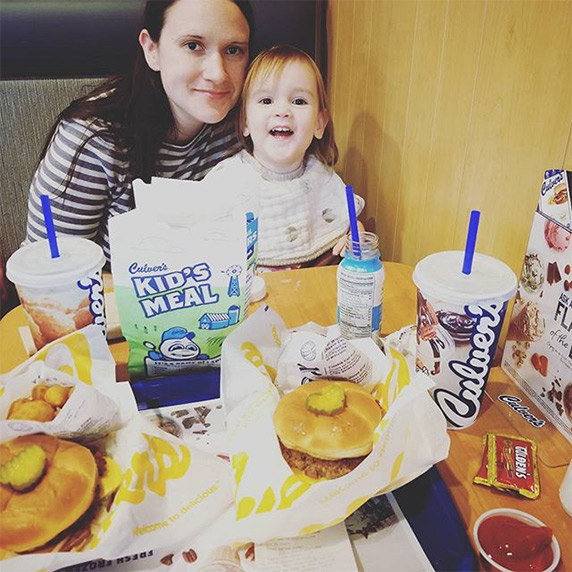 Mother and daughter sitting in Culver’s restaurant booth sharing their love for ButterBurgers®