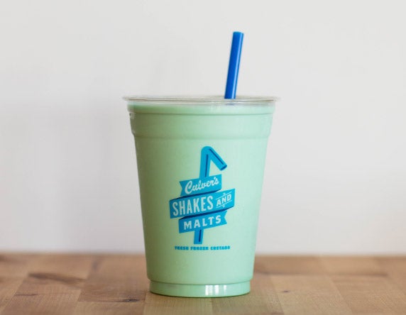 Culver's Mint Milkshake on a wooden table, waiting to be eaten.