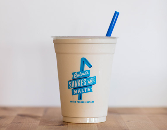 Culver's Salted Caramel Milkshake on a wooden table, waiting to be eaten.