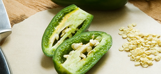 A sliced green pepper sits on a cutting board