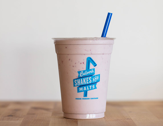 Culver's Raspberry Milkshake on a wooden table, waiting to be eaten.