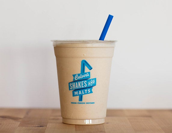 Culver's Peanut Butter Milkshake on a wooden table, waiting to be eaten.