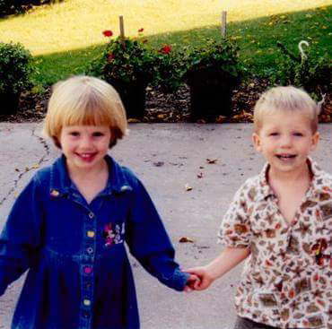 An old image of Kendal and Logan as little kids and holding hands.
