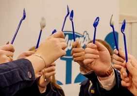 FFA members raise a blue spoon together in front of a Culver's logo.