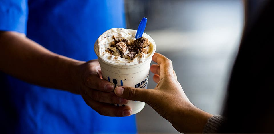 A True Blue Crew member handing off a Concrete Mixer