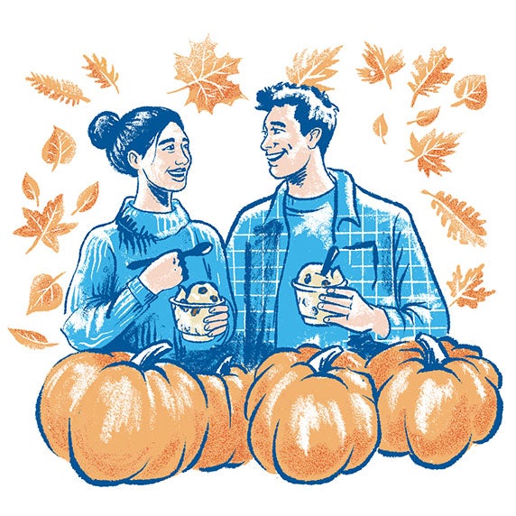 Two people enjoying dishes of Pumpkin Pecan Fresh Frozen Custard surrounded by pumpkins and leaves.