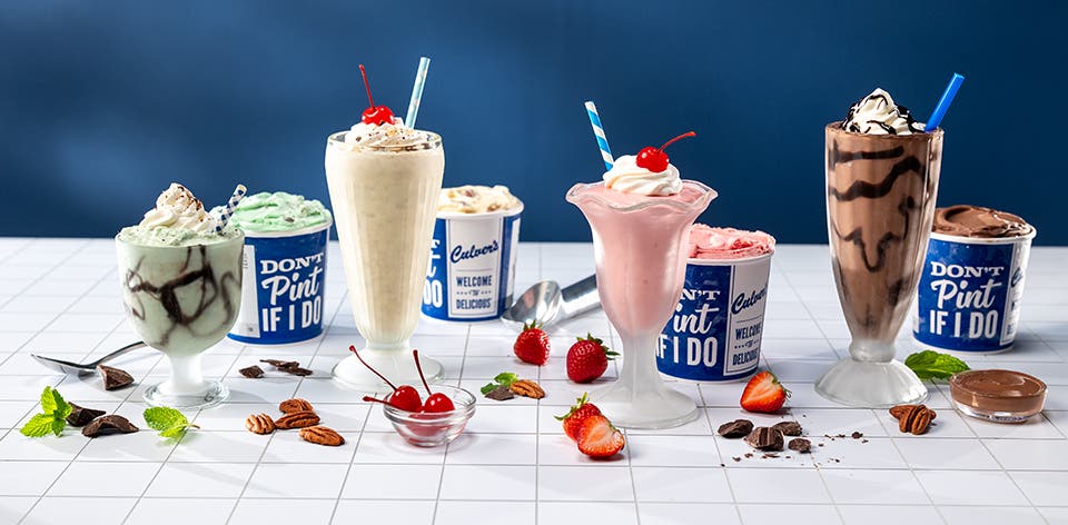 Grasshopper, Brandy Alexander, Pink Squirrel and Mudslide frozen custard mocktails in glasses sitting on a countertop. 