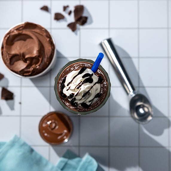 Mudslide frozen custard mocktail drink with whipped cream on top in a glass