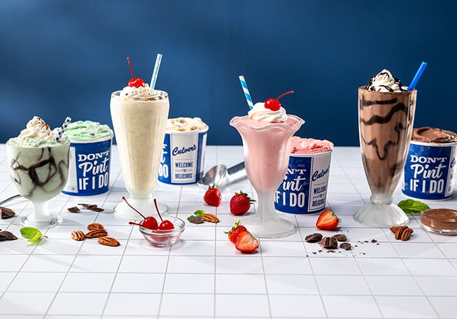 Grasshopper, Brandy Alexander, Pink Squirrel and Mudslide frozen custard mocktails in glasses sitting on a countertop. 