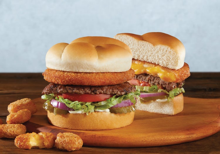 The CurderBurger sitting on a wooden tray.
