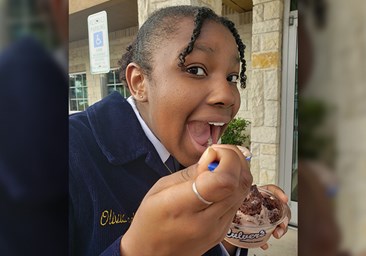 FFA member takes bite of Fresh Frozen Custard.