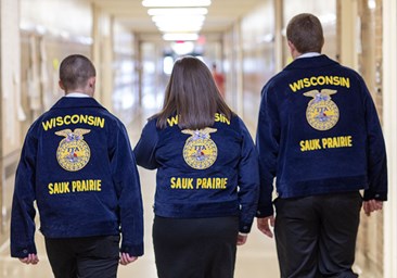 Link to story: 6 Ways we Supported Agricultural Education. Group of FFA members walking through hall